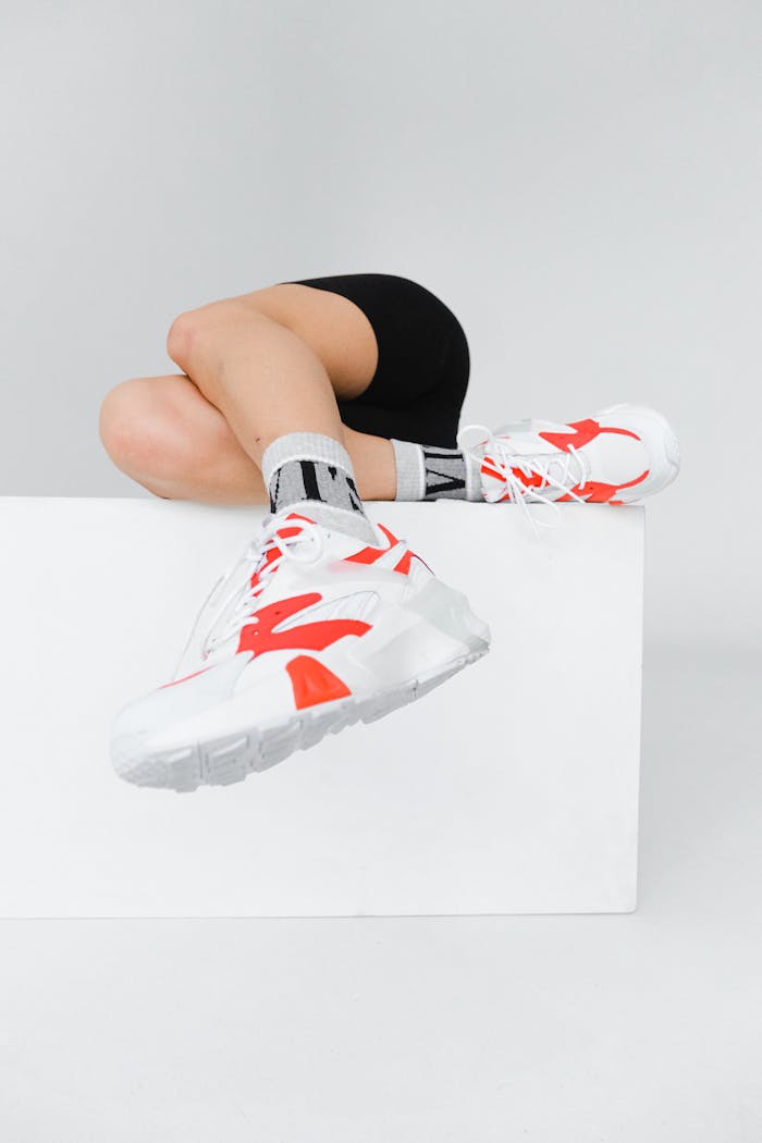 Close-up of trendy sports shoes with bright red accents on a white background, showcasing modern style.
